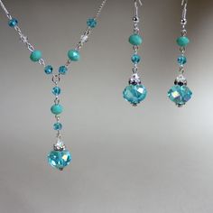 Vintage-look 2-piece jewellery set in beautiful shades of turquoise blue made with Swarovski crystals, glass crystals and rhinestones. Perfect for any occasion, weddings and parties or as a gift. Set contains drop necklace with delicate silver colour plated chain and a pair of long drop earrings.    Materials used:  Swarovski crystals, clear (4 mm), glass rondelle crystals, blue (12 mm), glass round crystals, blue (4 mm, 6 mm), rhinestone spacers, silver and antique silver colour plated base met Elegant Turquoise Jewelry Set For Party, Elegant Adjustable Turquoise Jewelry Set, Adjustable Turquoise Crystal Jewelry, Pearl Wedding Jewelry Sets, Wedding Party Bridesmaid, Rhinestone Jewelry Set, Pearl Jewelry Wedding, Bridesmaid Gifts Jewelry, Wedding Gifts For Bridesmaids