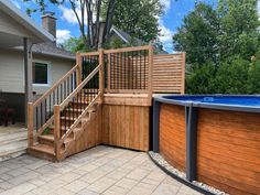 an above ground swimming pool with steps leading up to it and a wooden fence around it