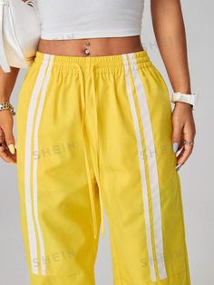 Style:Casual \nClosure Type:Elastic Waist \nDetails:Pocket \nDetails:Tape \nDetails:Side Stripe \nColor:Yellow \nPattern Type:Colorblock \nPattern Type:Striped \nType:Straight Leg \nWaist Line:Drop Waist \nLength:Long \nFit Type:Loose \nFabric:Non-Stretch \nMaterial:Woven Fabric \nComposition:100% Polyester \nCare Instructions:Machine wash or professional dry clean \nPockets:Yes \nTemperature:Spring/Fall (18-25℃/63-77℉) \nBody:Unlined \nSheer:No \n Trendy Streetwear, Women Pants, Side Stripe, Color Stripes, Drop Waist, Bright Color, Long Pants, Spring And Fall, Summer Women