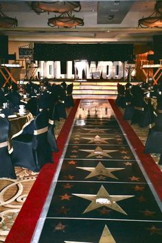 the entrance to hollywood is decorated with black chairs and red carpeted flooring that has gold stars on it