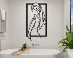 a white bath tub sitting next to a window in a bathroom with a painting on the wall