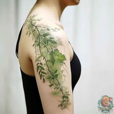 a woman with green leaves on her arm