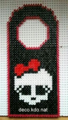 a black and white bag with a red bow on it's head is made out of legos