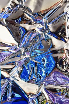 an abstract blue and silver background with lots of metallic foil in the foregrounds