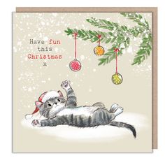 a christmas card with a cat laying under a tree and ornaments hanging from the branches