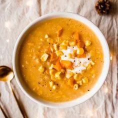 a bowl of soup with corn and cheese on top