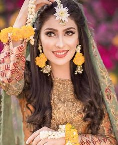 a woman in a bridal outfit with flowers on her head