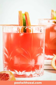 two glasses filled with blood orange punch and garnished with sliced grapefruit