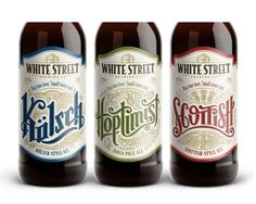 three bottles of white street ale on a white background