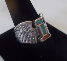 "NICE OLD VINTAGE G & S #1 WINGS RING. THESE ARE OLD STORE STOCK THAT I RECENTLY CAME ACROSS. I HAVE SEVERAL SIZES. THEY ARE GENUINE G & S RINGS. MOST ARE SIGNED, AND DATED, A COUPLE ARE NOT. IF THIS MATTERS TO YOU, PLEASE LET ME KNOW AND I WILL SEND YOU ONE THAT IS. THEY WEIGH OVER 7gm. FRONT MEASURES OVER 1/2\" HIGH. THEY HAVE TURQUOISE, AND CORAL INLAID IN THE #1. THEY HAVE BEEN STORED WELL, AND ARE IN NICE CONDITION. THE OLD G & S COMPANY MADE THEIR JEWELRY IN THE USA PRIOR TO BE Southwestern 925 Stamped Jewelry For Anniversary, Bohemian Inlay Jewelry For Anniversary, Southwestern Inlay Jewelry For Anniversary, Southwestern Style Inlay Jewelry For Anniversary, Wings Ring, Biker Jewelry, 80s Mens, Turquoise And Coral, Coral Ring