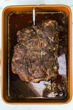 a piece of meat sitting in a pan on top of a table