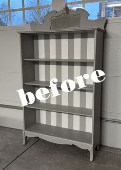 an old bookcase painted gray and white with the words before on it in front of a window