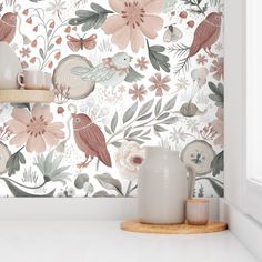 the wallpaper in this kitchen is painted with pink and green flowers, birds and leaves