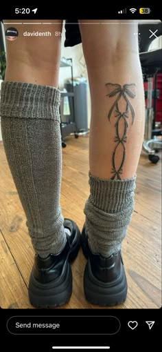 the legs and ankles of a person wearing socks with palm trees tattooed on their feet