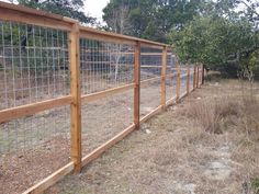 the fence is made of wood and wire