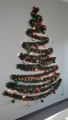 a decorated christmas tree hanging on the wall