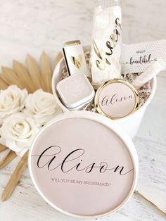 a basket filled with personalized items on top of a white table next to flowers