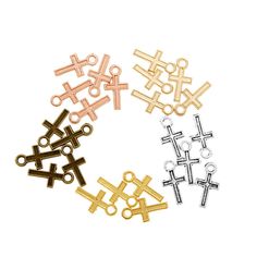 four different types of cross charms in various colors and sizes on a white background with space for text