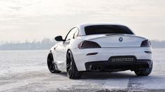 a white sports car parked in the snow