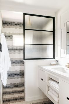 a bathroom with black and white stripes on the wall