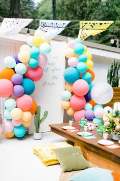 an outdoor party with balloons and decorations