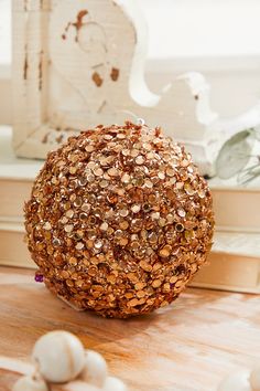 a decorative ball sitting on top of a wooden table