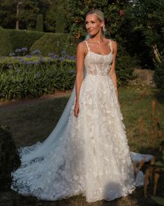 a woman in a wedding dress posing for the camera