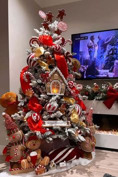 a christmas tree decorated with gingerbreads, candy canes and other holiday decorations