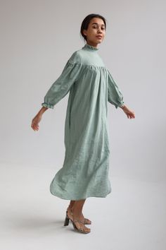 "Linen elegant dress with long wide sleeves, no shoulder line and delicate ruffle at the neck has tie detail in the back. Wide sleeves shrink with elastic at the bottom. Loose cut dress is comfy yet elegant and can be worn for various occasions. You can wear it without belt for romantic and free style or use belt to create more classic look. Belt is long enough to go around waist twice! For more chic look, style it with accessories. Double washed for extra softness and shrinkage prevention. ABOU Summer Maxi Dress With Gathered Bishop Sleeves, Elegant Billowy Cotton Dress, Elegant Cotton Dresses With Bishop Sleeves, Elegant Peasant Dress With Gathered Sleeves For Spring, Elegant Spring Peasant Dress With Gathered Sleeves, Relaxed Fit Dress With Pleated Sleeves For Daywear, Elegant Spring Prairie Dress For Gatherings, Elegant Dresses With Gathered Sleeves For Gatherings, Vintage Summer Dress With Smocked Cuffs