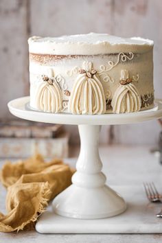 a white cake with frosting and decorative decorations