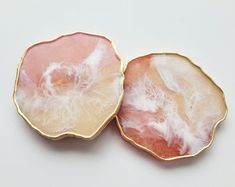 two pink and white plates sitting on top of each other