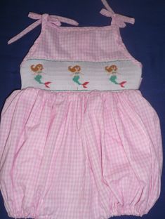 Hand-smocked bubble. Light pink gingham checked fabric. Ties at the shoulders and at the back. For custom orders allow 2-3 weeks for delivery. Cute Gingham Smocked Summer Dress, Cute Gingham Smocked Dress For Summer, Playful Pink Fitted Smocked Dress, Playful Ruffled Smocked Dress For Beach, Pink Smocked Back Dress For Beach, Cute Smocked Dress For The Beach, White Smocked Dress, Checked Fabric, Bubble Bubble