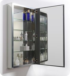 the medicine cabinet has many bottles and containers on it's glass shelves, as well as an illuminated mirror