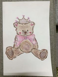 a drawing of a teddy bear with a crown on it's head sitting in front of a piece of paper