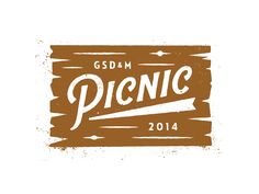 a wooden sign with the word picnic written in white and brown on top of it