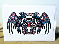 a card with an eagle design on it's front and back wings in red, blue, and black