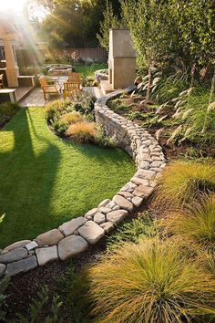 an outdoor garden with grass and stone walls