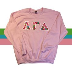 Pink Crew Sweatshirt With Embroidered Graphics, Pink Winter Sweatshirt With Embroidered Graphics, Winter Pink Sweatshirt With Embroidered Graphics, Pink Long Sleeve Top With Letter Embroidery, Pink Long Sleeve Sweatshirt With Embroidered Text, Pink Tops With Embroidered Graphics For Winter, Pink Top With Letter Embroidery For Winter, Pink Long Sleeve Sweatshirt With Lettering, Pink Crew Neck Sweatshirt With Letter Print