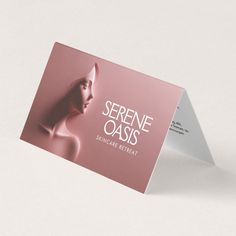 a pink business card with an image of a woman's head on the front