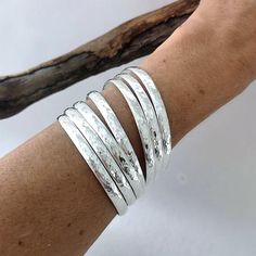 This stunning and elegant set of 7 bangles are individually handmade in Mexico.Handcrafted to the highest quality from 6mm solid half round wire, hammered by hand, they are polished and silver plated.They make a lovely tune when they jangle together!The Semanario (7 day bracelet) is an very traditional Mexican gift, they symbolize each day of the week.The bangles are 8" inches in circumference and 2.5" inches in diameter. If you've got any questions don't hesitate to ask me.These bangles come gi Bangles Silver, 7 Design, Hammered Bangles, Stackable Bangles, Stacking Bracelets, Mexican Jewelry, Sterling Silver Bangle Bracelets, The Bangles, Traditional Mexican