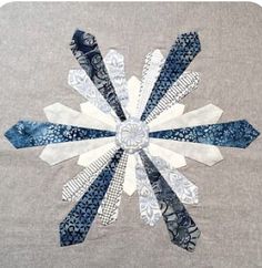 a snowflake made out of blue and white fabric