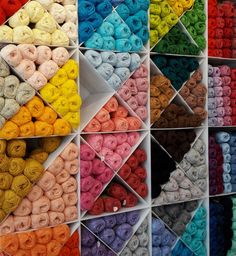 there are many different colors of yarn on display