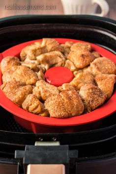 a red plate filled with food on top of an air fryer