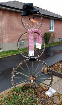 a scarecrow made out of an old bicycle wheel