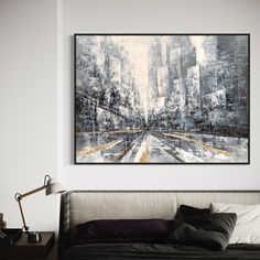 a painting hanging on the wall above a bed