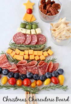 a christmas tree made out of cheese, meats and vegetables with the words christmas charcute board