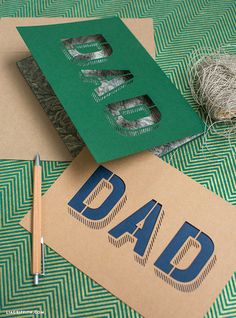 two pieces of paper cut out to look like dad's day cards with twine