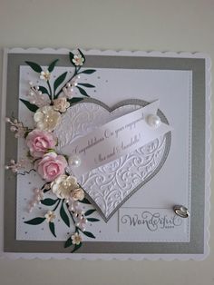 a wedding card with flowers and pearls on the front, in grey and white colors