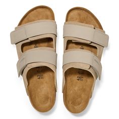 The Uji Slide Sandal in Taupe Suede Nubuck from Birkenstock. A sport-inspired take on the iconic Arizona sandal, the Uji maximizes on-the-go comfort. A suede upper comes together softly over the foot, secured by nubuck hook-and-loop straps for a customized fit. The style is grounded in signature BIRKENSTOCK support, with a cork-latex footbed that shapes to you with wear. Slip on and go. Contoured cork-latex footbed creates custom support with wear Suede upper with two nubuck leather hook-and-loo Mens Blundstone, Birkenstock Men, Sporty Aesthetic, Double Strap Sandals, Mens Skechers, Birkenstock Sandals, Mens Uggs, Zermatt, Timberlands Women