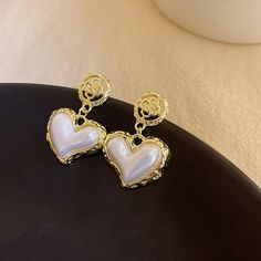 Heart Shaped Pearl Earrings As Gift, Heart-shaped Pearl Earrings For Valentine's Day, White Heart Charm Earrings, White Heart-shaped Pearl Earrings For Valentine's Day, White Heart Drop Earrings For Mother's Day, Valentine's Day White Pearl Earrings, White Heart-shaped Pearl Earrings For Pierced Ears, Heart-shaped White Pearl Earrings For Pierced Ears, Trendy White Earrings For Mother's Day